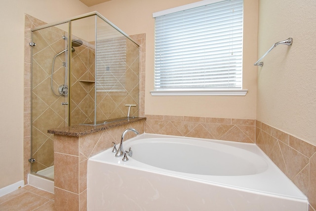 bathroom featuring plus walk in shower and tile patterned floors