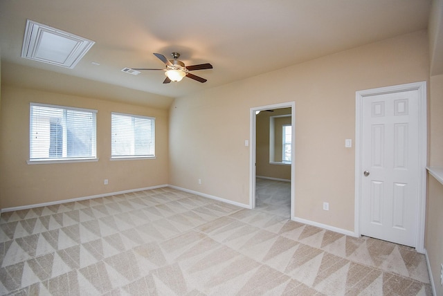 empty room with light carpet, ceiling fan, and lofted ceiling