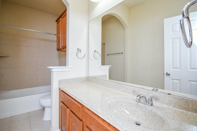 full bathroom with tile patterned flooring, vanity, toilet, and tiled shower / bath