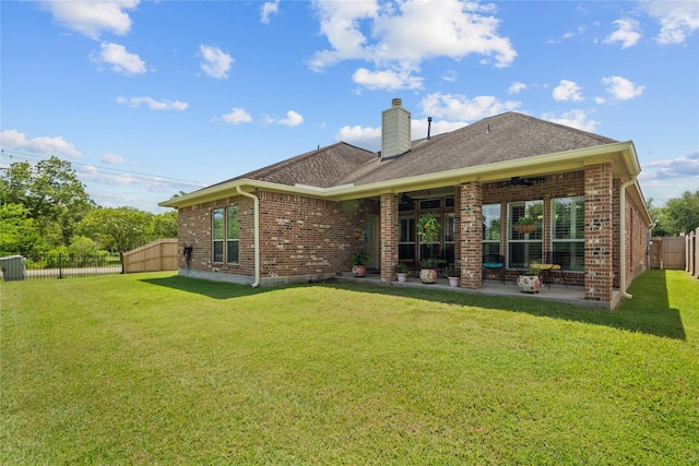 back of property featuring a patio and a lawn