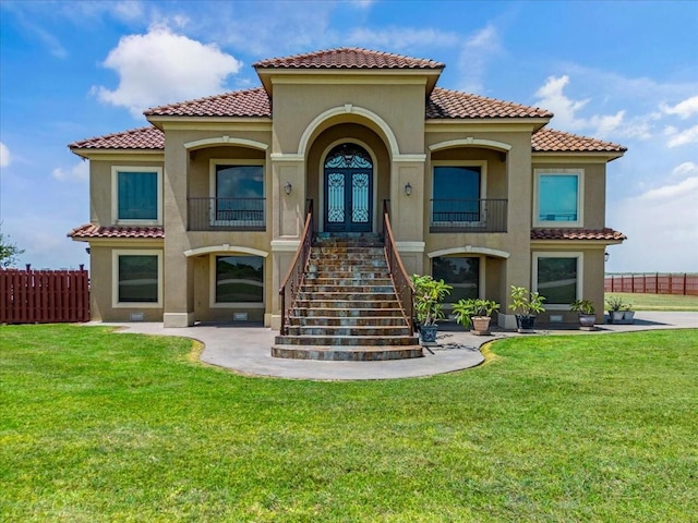 mediterranean / spanish-style house featuring a front lawn