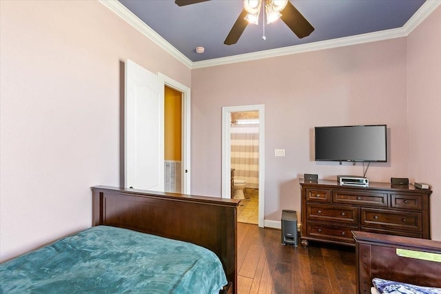 bedroom featuring dark hardwood / wood-style flooring, connected bathroom, ceiling fan, and crown molding