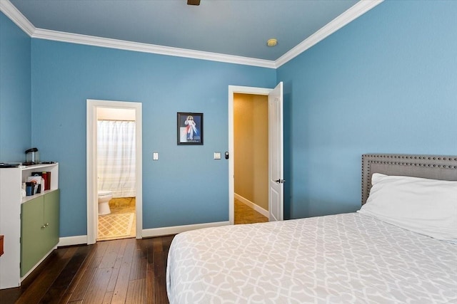 bedroom featuring connected bathroom, dark hardwood / wood-style floors, and ornamental molding