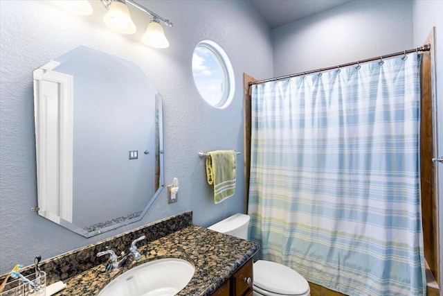 full bathroom featuring shower / bath combo, vanity, and toilet