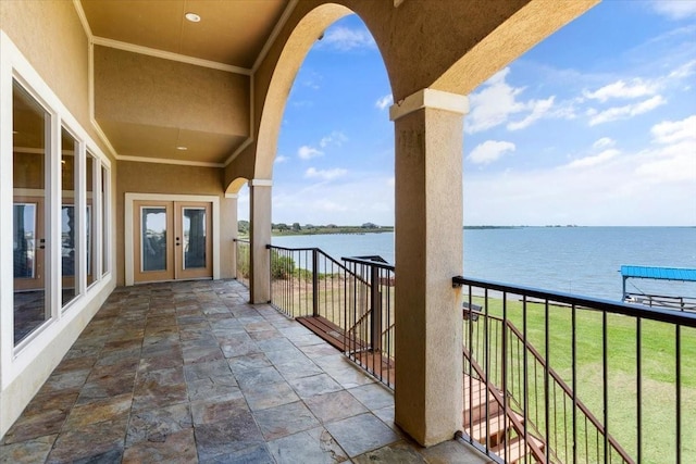 balcony with french doors and a water view