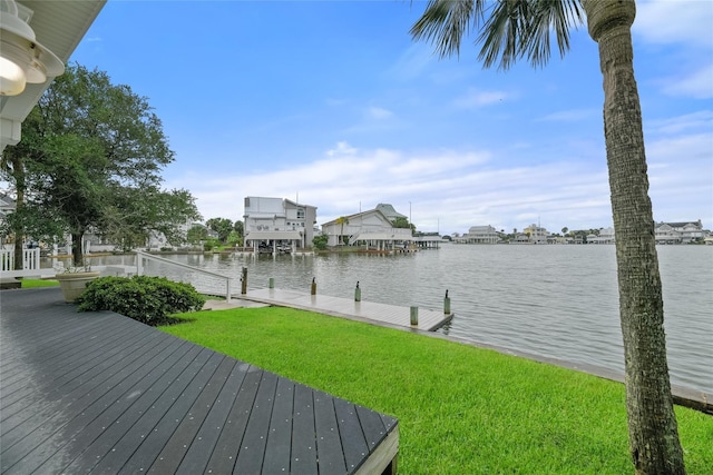 view of dock featuring a water view and a yard