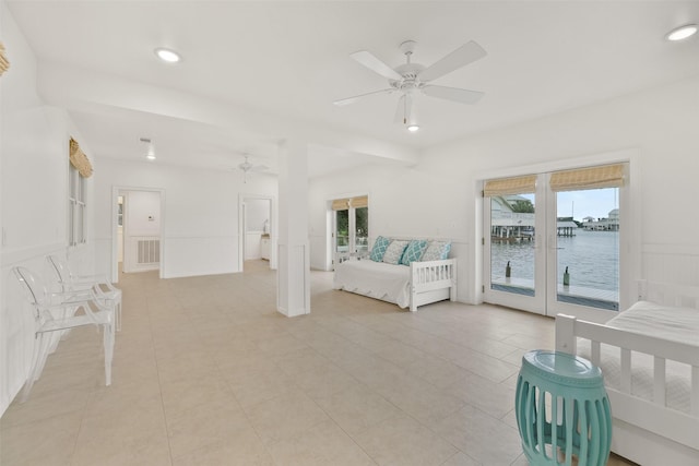 unfurnished bedroom with access to outside, a water view, ceiling fan, and light tile patterned flooring