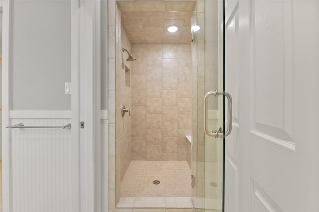 bathroom featuring tile patterned flooring and a shower with shower door