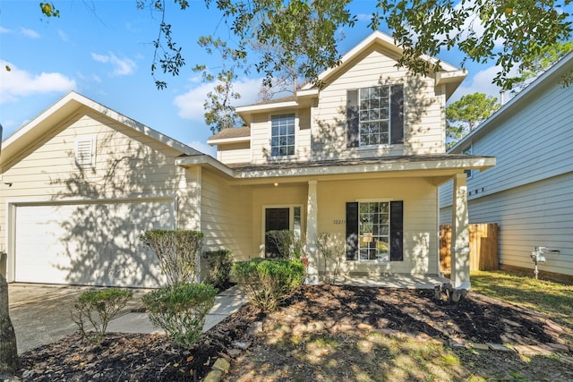 front facade featuring covered porch and a garage