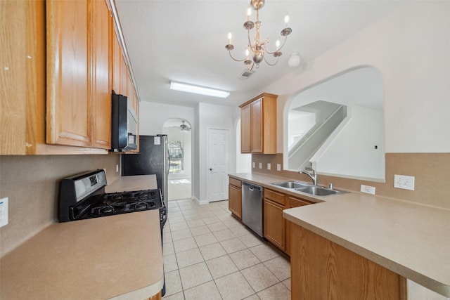 kitchen with sink, decorative light fixtures, light tile patterned floors, black appliances, and ceiling fan with notable chandelier