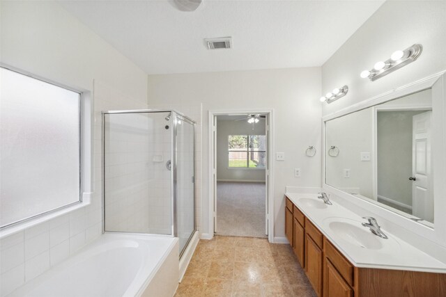 bathroom with shower with separate bathtub, vanity, and tile patterned floors