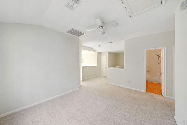 carpeted empty room with vaulted ceiling and ceiling fan