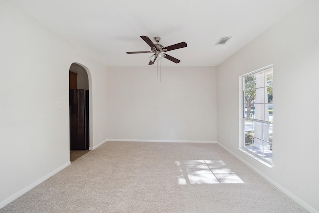 spare room with light carpet and ceiling fan