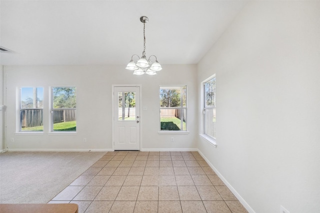 entryway featuring a chandelier and light tile patterned flooring