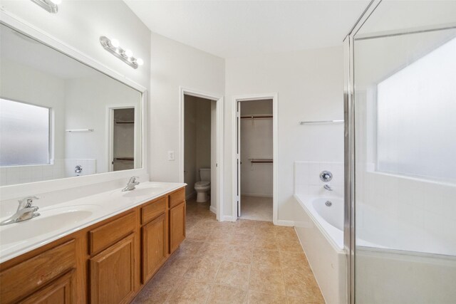 full bathroom with separate shower and tub, tile patterned flooring, vanity, and toilet