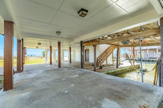 view of patio featuring a water view and a boat dock