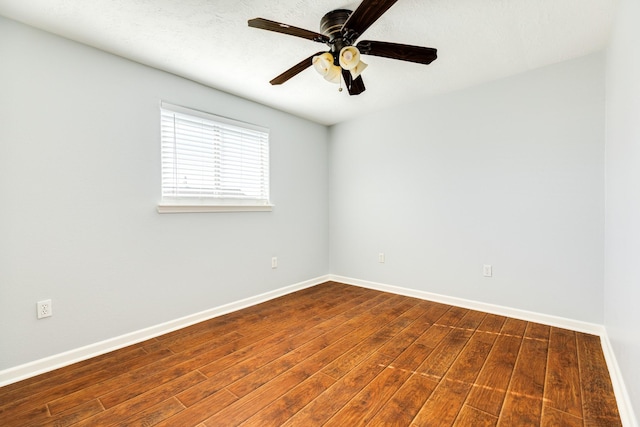 spare room featuring hardwood / wood-style floors and ceiling fan