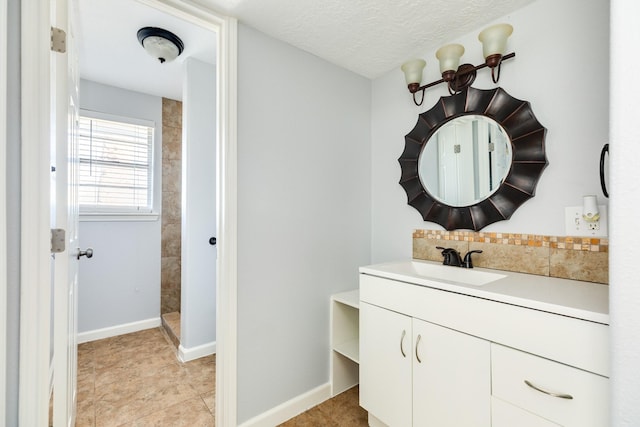 bathroom with a textured ceiling and vanity