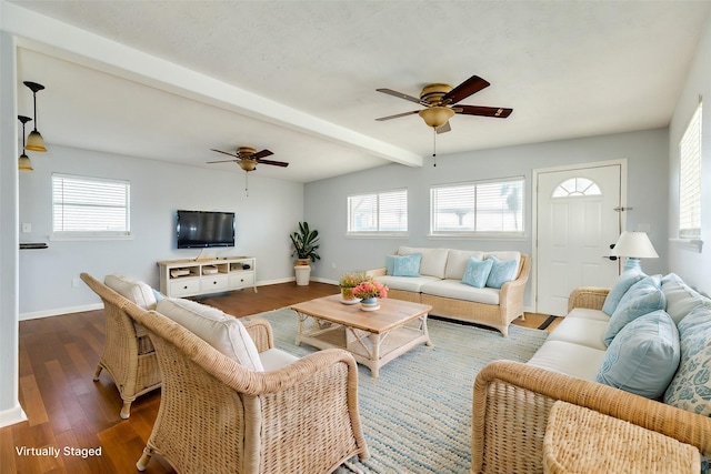 living room with hardwood / wood-style flooring, ceiling fan, and lofted ceiling with beams