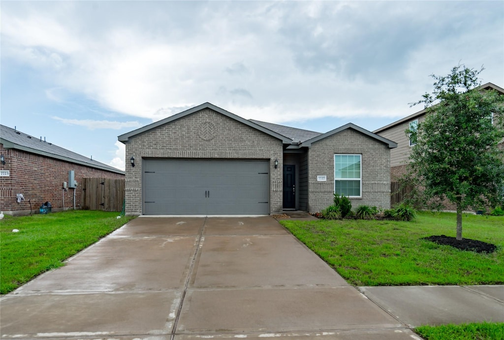 ranch-style house with a garage and a front lawn