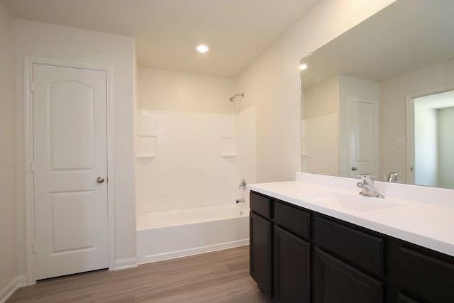 bathroom featuring vanity, wood-type flooring, and shower / bathtub combination