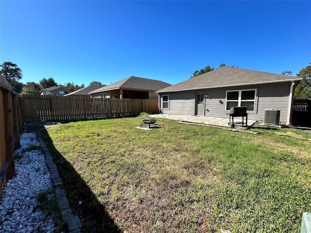 view of yard featuring central air condition unit, a patio, and a fire pit