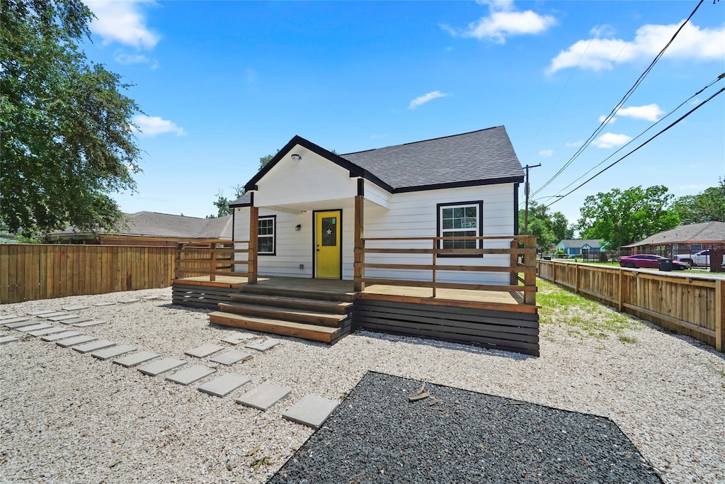 view of front of home featuring covered porch and a deck