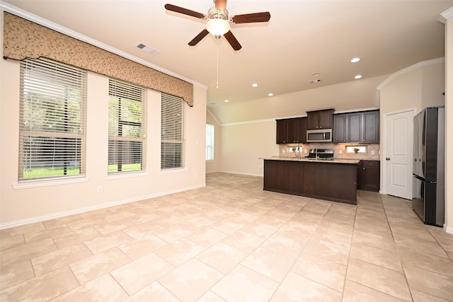 kitchen featuring a center island with sink, ceiling fan, ornamental molding, tasteful backsplash, and stainless steel appliances