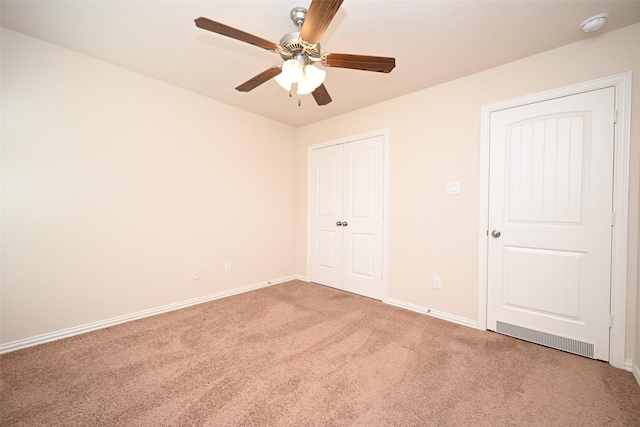 unfurnished bedroom with carpet flooring, ceiling fan, and a closet