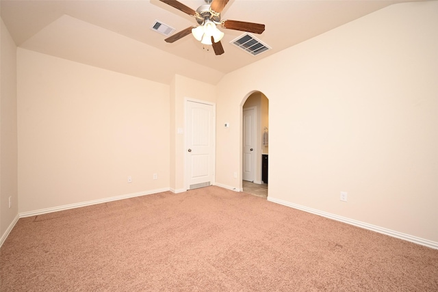 spare room featuring ceiling fan, carpet, and vaulted ceiling