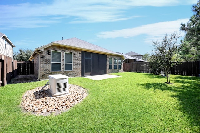 rear view of house featuring a lawn