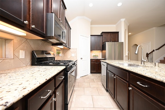 kitchen featuring sink, stainless steel appliances, tasteful backsplash, crown molding, and light tile patterned flooring