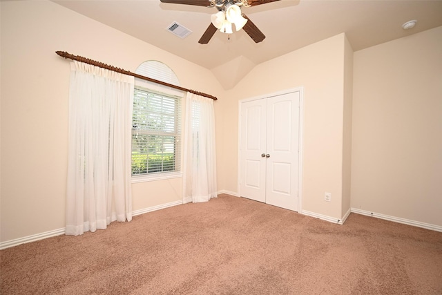 unfurnished bedroom with carpet, ceiling fan, and a closet