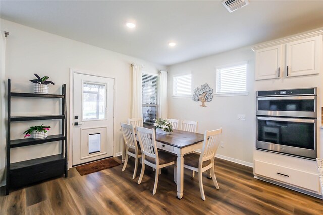 dining room featuring dark hardwood / wood-style floors and a wealth of natural light