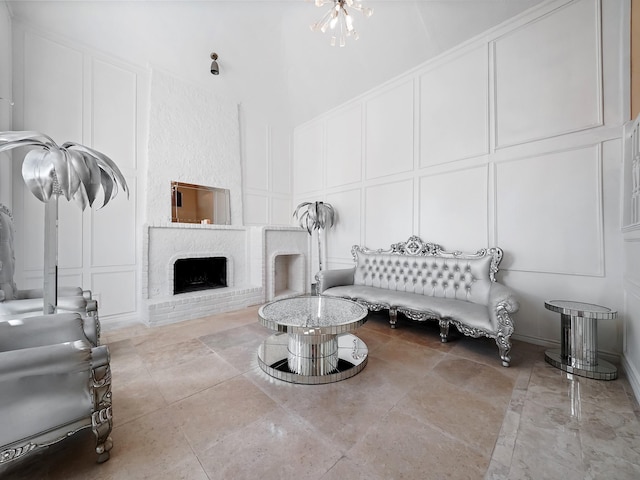 living room with a fireplace and a towering ceiling