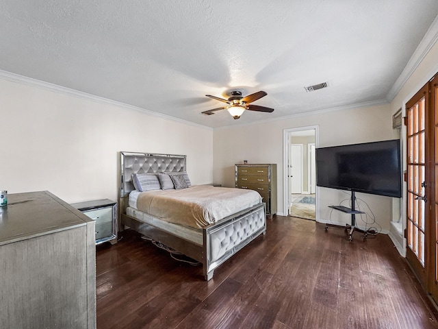 bedroom with ceiling fan, dark hardwood / wood-style flooring, ornamental molding, and a textured ceiling