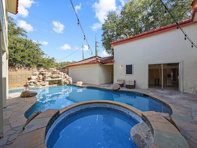 view of swimming pool featuring an in ground hot tub