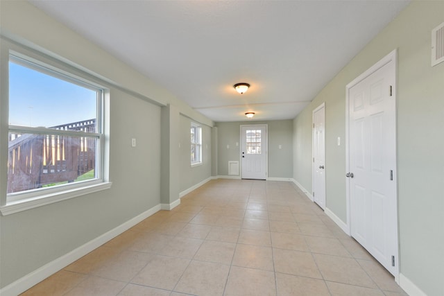 doorway featuring light tile patterned flooring