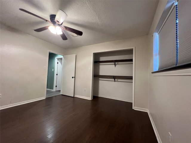 unfurnished bedroom with dark hardwood / wood-style flooring, a textured ceiling, a closet, and ceiling fan