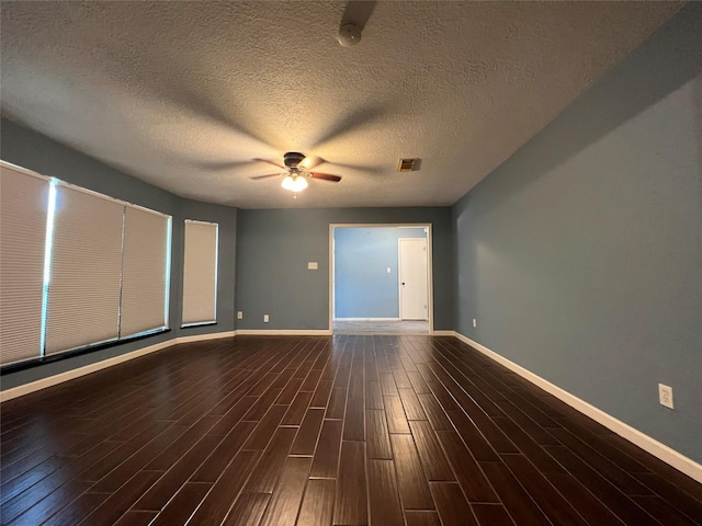 unfurnished room featuring a textured ceiling, ceiling fan, and dark wood-type flooring