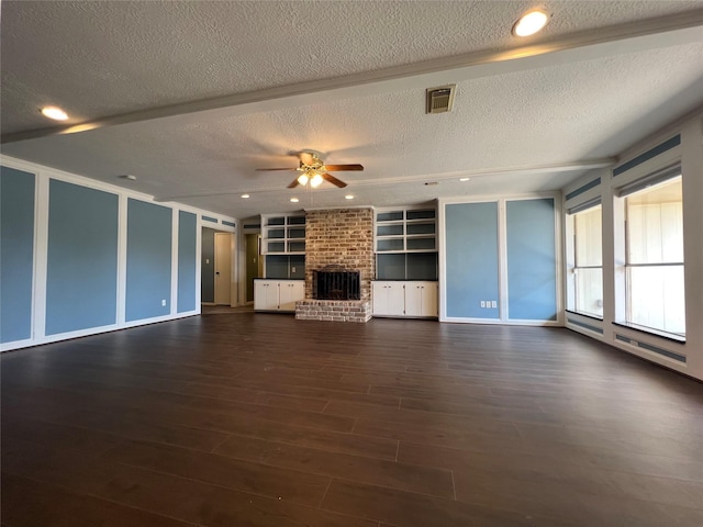 unfurnished living room featuring dark hardwood / wood-style flooring, ceiling fan, a fireplace, and a textured ceiling