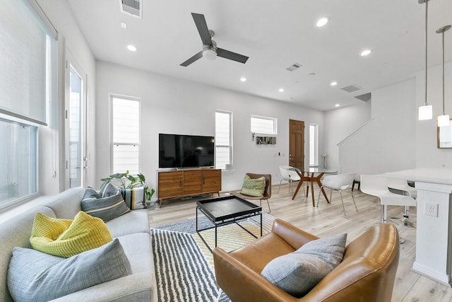 living room featuring ceiling fan and light hardwood / wood-style flooring