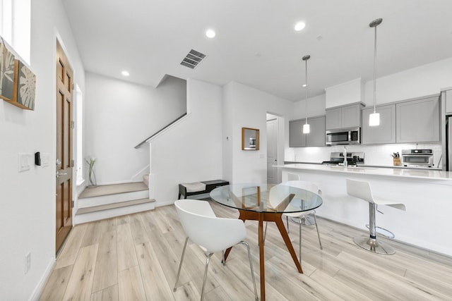 dining area with light hardwood / wood-style floors