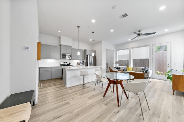 dining space featuring light hardwood / wood-style floors and ceiling fan