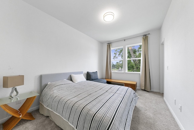 bedroom featuring light colored carpet