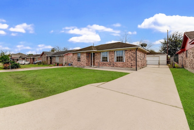 ranch-style house featuring a garage, an outbuilding, and a front lawn