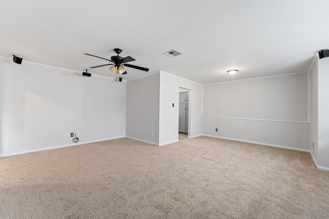 carpeted spare room featuring ornamental molding and ceiling fan