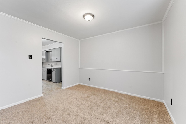 empty room featuring crown molding and light carpet