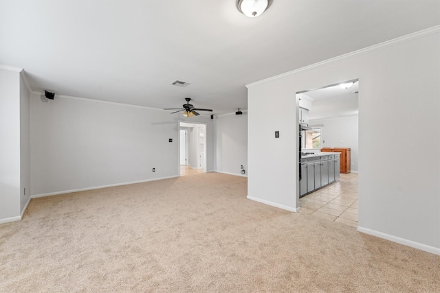 unfurnished room featuring light carpet, ornamental molding, and ceiling fan