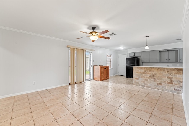 kitchen featuring gray cabinetry, light tile patterned floors, ceiling fan, crown molding, and black fridge